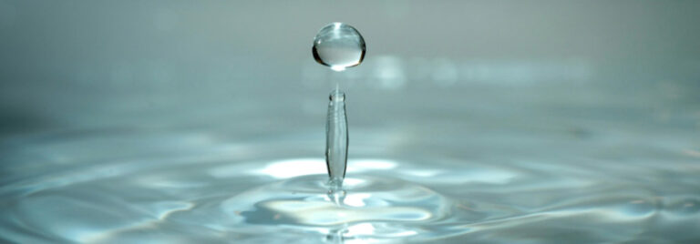 Industrial brine treatment system with membrane filtration and vacuum evaporation to achieve zero liquid discharge (ZLD)
